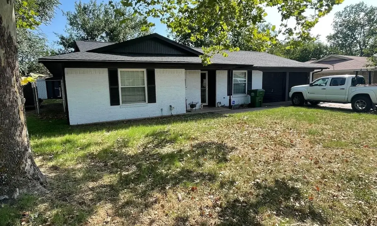 Professional roofing crew working on a residential roof in Surfside